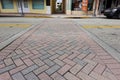 A Pedestrian crosswalk in Downtown Ft. Pierce, FL made of brick pavers in a herringbone pattern