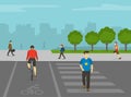 Pedestrian and cyclist crossing the shared road on pedestrian crossing marking. Shared-use path with crosswalk. Royalty Free Stock Photo