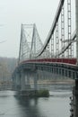 Pedestrian empty bridge in Kyiv on a rainy foggy day