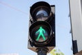 Pedestrian green traffic light on blue sky background Royalty Free Stock Photo