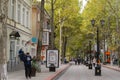 Pedestrian Lenin Street in center of Kerch city. People calmly walk along shady alley of tall plane trees