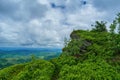 Pedestrian narrow path among green blueberry bushes and a rocky ledge on top of a mountain. Summer landscape in the Carpathian Royalty Free Stock Photo