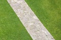 Pedestrian old stone footpath on a grass area of a public park Royalty Free Stock Photo