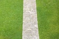 Pedestrian old stone footpath on a grass area of a public park Royalty Free Stock Photo