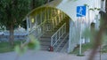 The pedestrian overpass is equipped with a modern ramp for disabled people. iron railing elements and colored glass. infrastructur