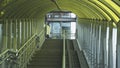 The pedestrian overpass is equipped with a modern ramp for disabled people. iron railing elements and colored glass. infrastructur