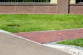 Pedestrian pavement made of red tiles.