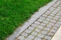 A pedestrian pavement made of stone cobble and granite tiles.