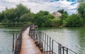 Pedestrian pontoon-bridge over small river Schemylivka in outskirts of Dnipro city, Ukraine Royalty Free Stock Photo