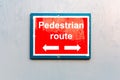 Pedestrian route direction red painted notice board