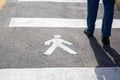 Pedestrian sign on the asphalt and human legs walking Royalty Free Stock Photo