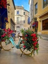 Pedestrian street of Nimes with flowers bicycle Royalty Free Stock Photo