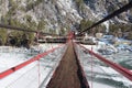 Pedestrian suspension bridge over the Katun River near the village  Barangol, Altai Republic, Russia Royalty Free Stock Photo