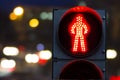 Pedestrian traffic lights red on a background of cars