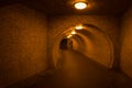 Pedestrian tunnel illuminated by warm lights, Budapest, Hungary