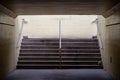 Pedestrian tunnel walkway with stairs light at end