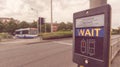 Pedestrian Wait Sign at Pelican crossing in both English and Welsh languages B Royalty Free Stock Photo