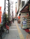 Pedestrian walk with bicycle parking and row of shop, Osaka 2016
