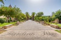 Pedestrian walk in Giardini Iblei in Ragusa Ibla with palm trees and plants