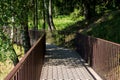 Pedestrian walking deck with railings laid between birches in the park Royalty Free Stock Photo