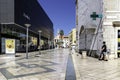 Pedestrian walks down a street with modern shops. Split, Croatia.