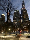 Pedestrian walks in New York`s Central Park against the backdrop of Manhattan skyscrapers in the evening in winter Royalty Free Stock Photo