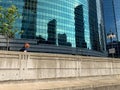 Pedestrian walks on Upper Wacker Drive, where a dividing wall marks III for the 3 forks of the Chicago River