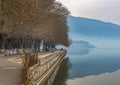 Pedestrian walkway for exercise or bikes lined up with beautiful tall trees in lake Pamvotis, Ioannina city. Greece Royalty Free Stock Photo