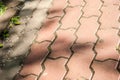 The pedestrian walkway is paved with red brick paving slabs, on it is a pattern of shadows from trees. texture, roughness Royalty Free Stock Photo
