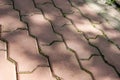 The pedestrian walkway is paved with red brick paving slabs, on it is a pattern of shadows from trees. texture, roughness Royalty Free Stock Photo