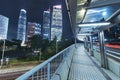 pedestrian walkway and skyscraper in Hong Kong city at night Royalty Free Stock Photo