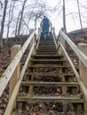 Pedestrian wooden stairs, tree leaves on footbridge, autumn day