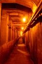 Pedestrian zone of an underground tunnel illuminated by light bulbs Royalty Free Stock Photo