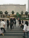 Pedestrians crossing the zebra crossing in front of the Indonesian plaza