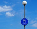 Pedestrians and cyclists zone sign. Blue signpost with silhouettes of mother, child and bicycle on a street lamp.