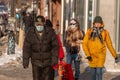 Pedestrians with face masks for protection from COVID-19 walking down the street