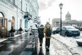 Pedestrians pass Nevsky Prospekt and Griboedova Canal near the Kazan cathedral, St. Petersburg, Russia