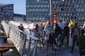 Pedestrians and people with bycycles waiting for a footbridge  to close before they can cross the water. Royalty Free Stock Photo