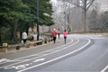 Runners in Central Park roadway practice social distancing Royalty Free Stock Photo