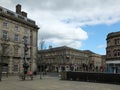 Pedestrians in St Georges Square walk past the historic old stone buildings around the pedestrian area