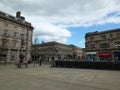 Pedestrians in St Georges Square walk past the historic old stone buildings around the pedestrian area