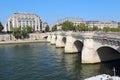 Pedestrians and traffic on the Pont Neuf in Paris, France