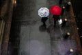 Pedestrians with umbrellas on a sidewalk in Manhattan.