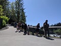 Pedestrians viewing the majestic Snoqualmie Falls from one of the viewpoints on a sunny day