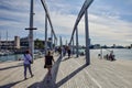 pedestrians walk across the bridge over the strait. Barcelona