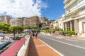 Pedestrians walk the Grand Prix street race circuit near St Devote in Monte Carlo, Monaco. Royalty Free Stock Photo