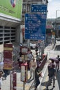 Pedestrians walk by a large sign in Hong Kong.