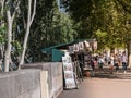 Pedestrians walk past book stalls along the Seine