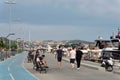 Pedestrians walking by the Bosphorus between Bebek and Hisari districts, and docked boats and yachts, Istanbul, Turkey Royalty Free Stock Photo