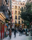 Madrid, Spain, November 28, 2021: Pedestrians walking on Calle de la Victoria in Madrid, Spain